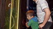 Two children looking at a display case